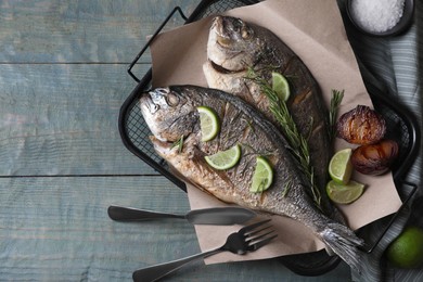 Delicious baked fish served on wooden rustic table, flat lay with space for text. Seafood