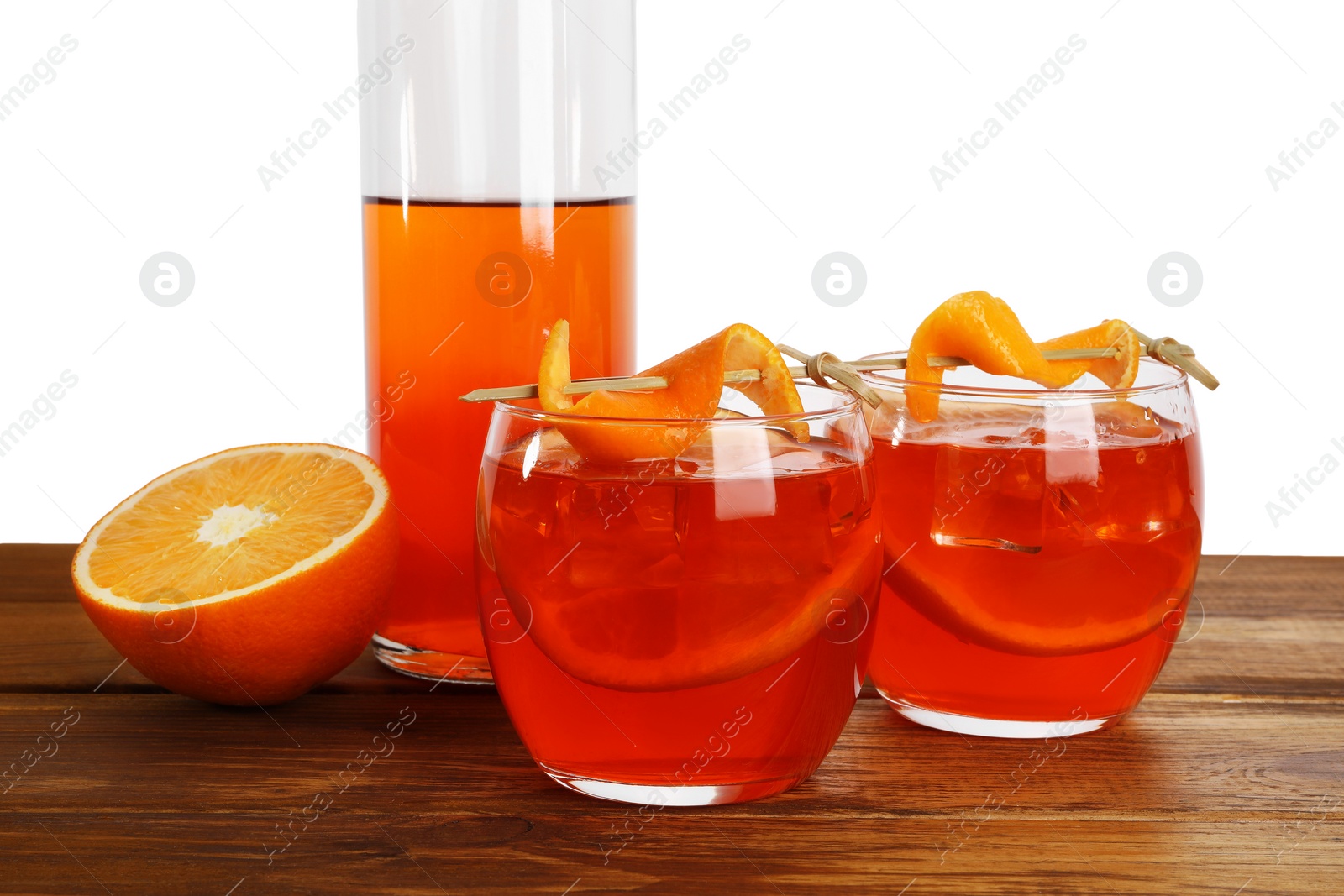 Photo of Aperol spritz cocktail and orange slices in glasses on wooden table against white background