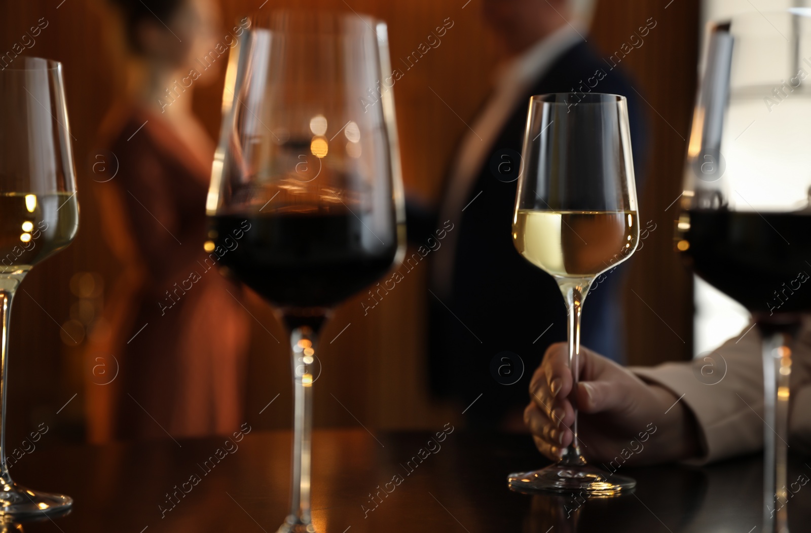 Photo of Woman with glass of wine in restaurant, closeup