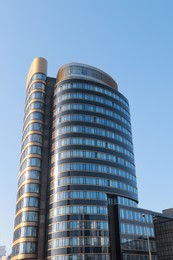 Low angle view of modern building on sunny day