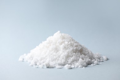 Photo of Heap of natural salt on color background