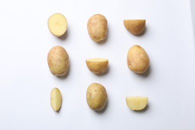 Photo of Fresh raw potatoes on white background, flat lay