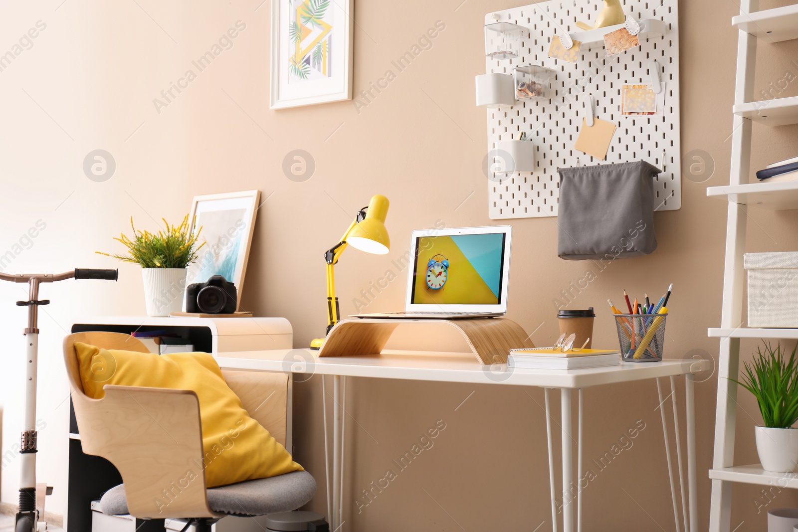 Photo of Modern laptop on desk in room. Home workplace