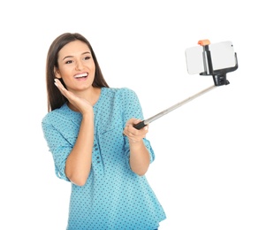 Photo of Young beautiful woman taking selfie against white background