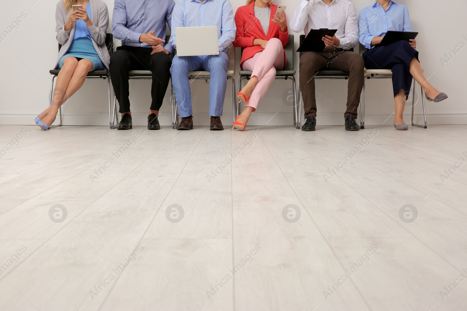Photo of Group of young people waiting for job interview on chairs