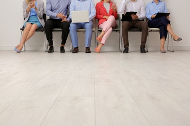 Photo of Group of young people waiting for job interview on chairs