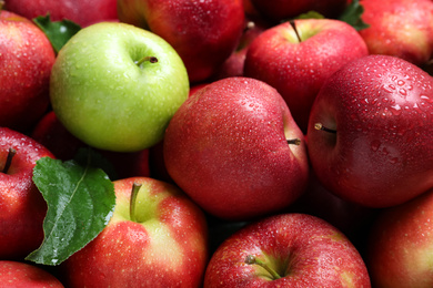 Photo of Tasty red apples and green one as background, closeup