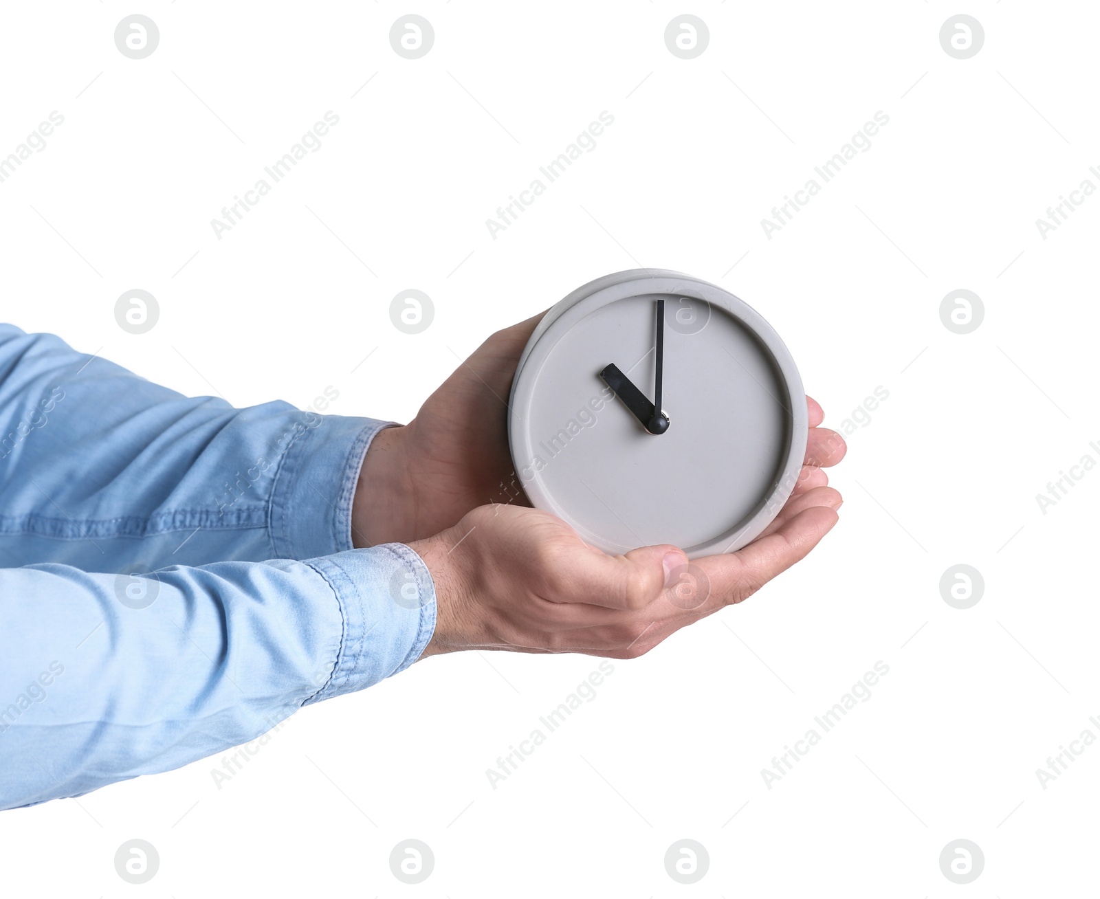 Photo of Young man holding alarm clock on white background. Time concept