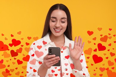 Image of Long distance love. Woman video chatting with sweetheart via smartphone on golden background. Hearts flying out of device