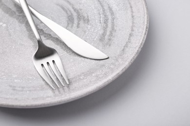Setting with stylish cutlery on grey table, closeup. Space for text