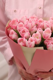 Photo of Woman with bouquet of beautiful fresh tulips on blurred background, closeup