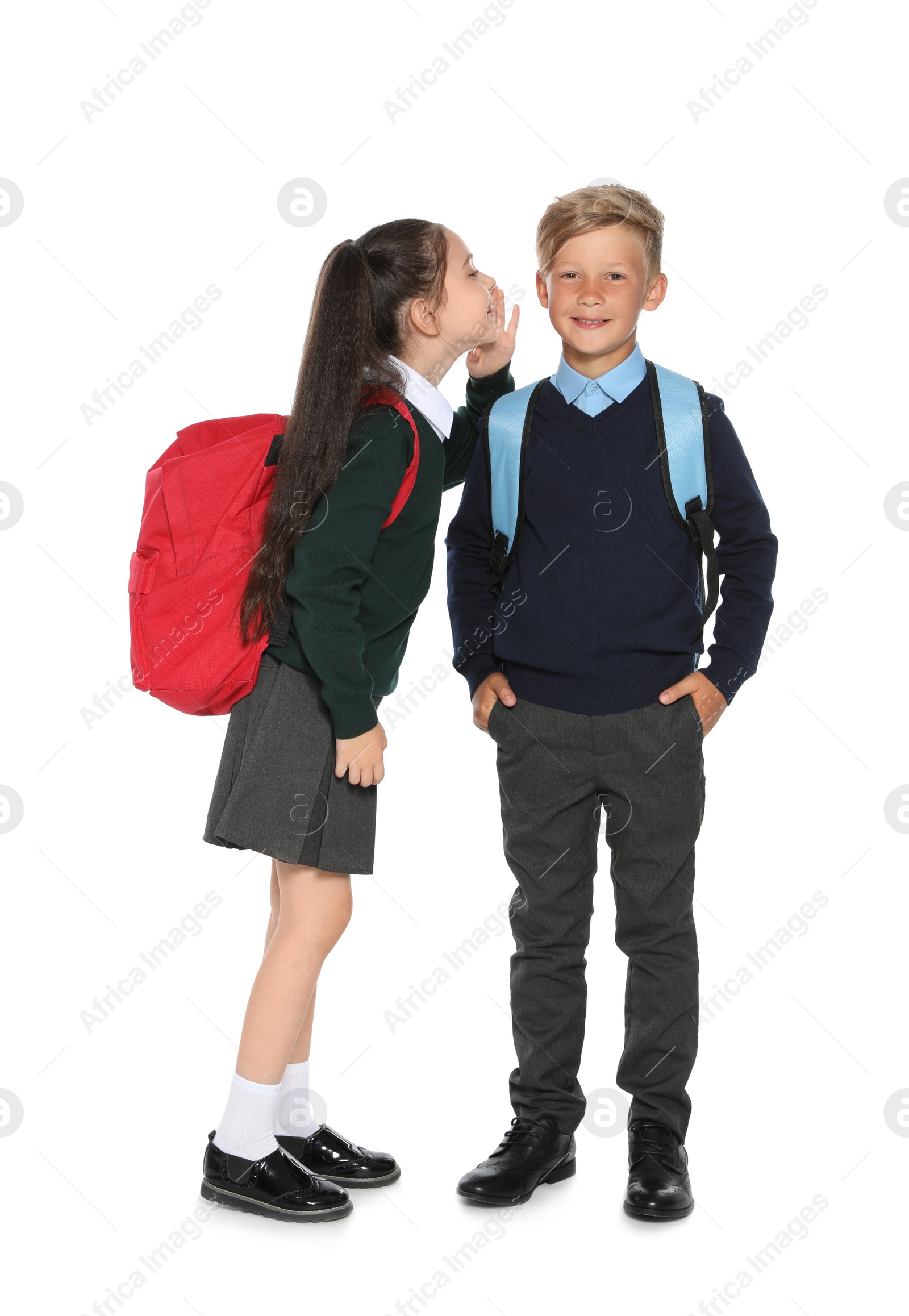 Photo of Little children in stylish school uniform on white background