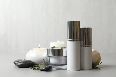 Composition with cosmetic products on light grey stone table
