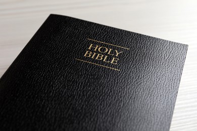 Holy Bible on white wooden table, closeup