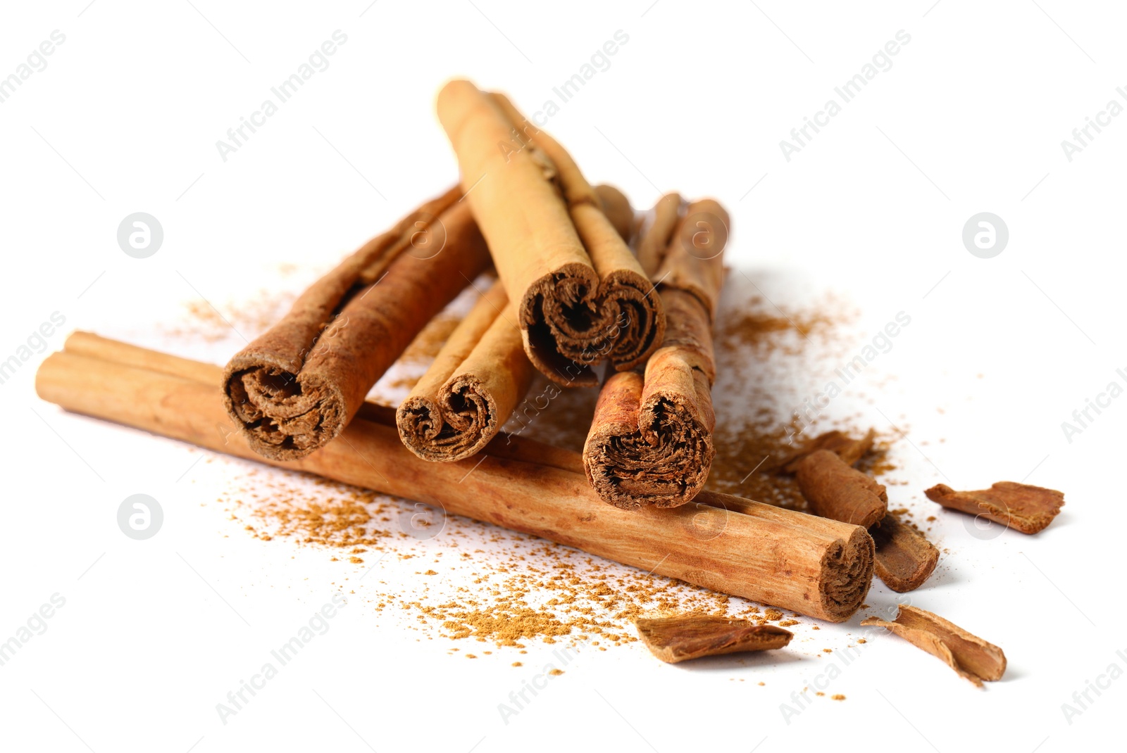 Photo of Dry aromatic cinnamon sticks and powder isolated on white