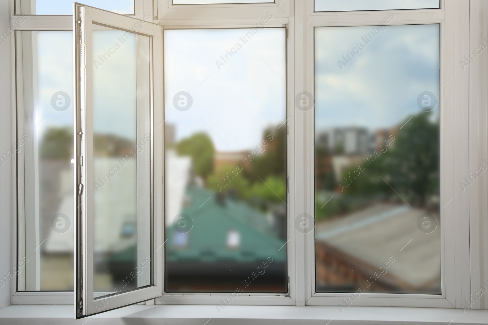 Photo of Open window with white plastic frame indoors