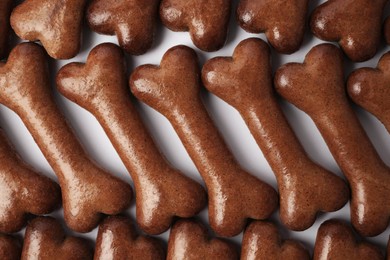 Photo of Flat lay composition with many bone shaped dog cookies on white background