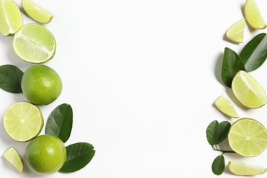 Fresh ripe limes and leaves on white background, flat lay. Space for text