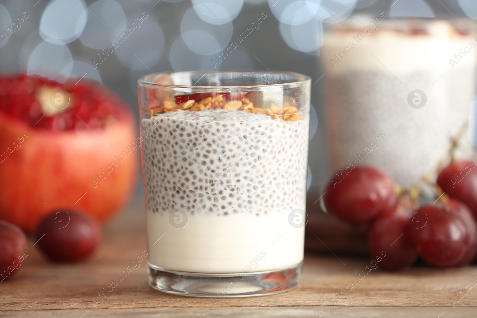 Photo of Tasty chia seed pudding with on table against blurred background