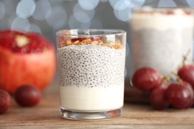 Tasty chia seed pudding with on table against blurred background