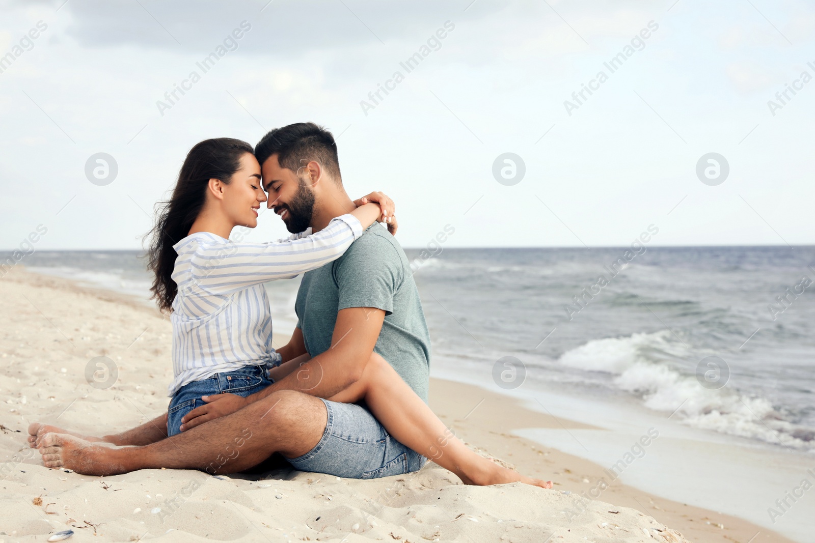 Photo of Lovely couple spending time together on beach