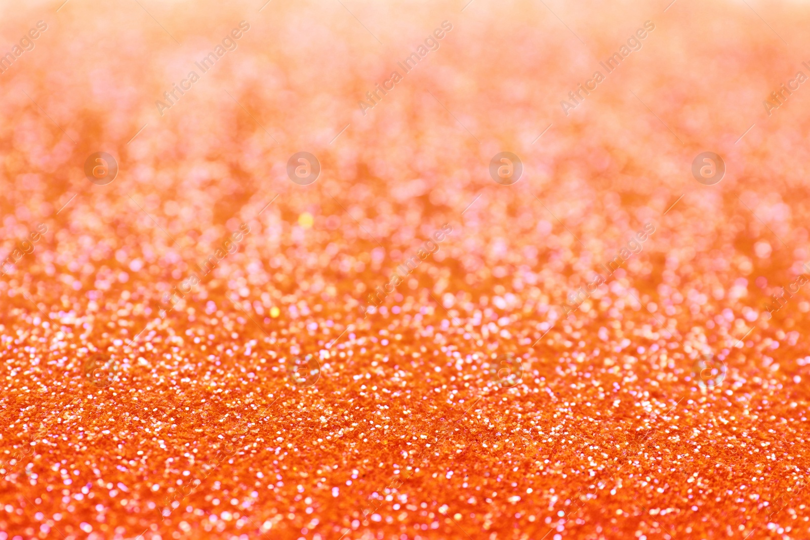 Photo of Shiny orange glitter as background. Bokeh effect