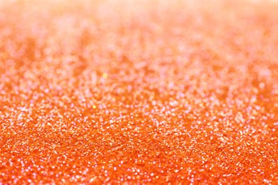 Shiny orange glitter as background. Bokeh effect