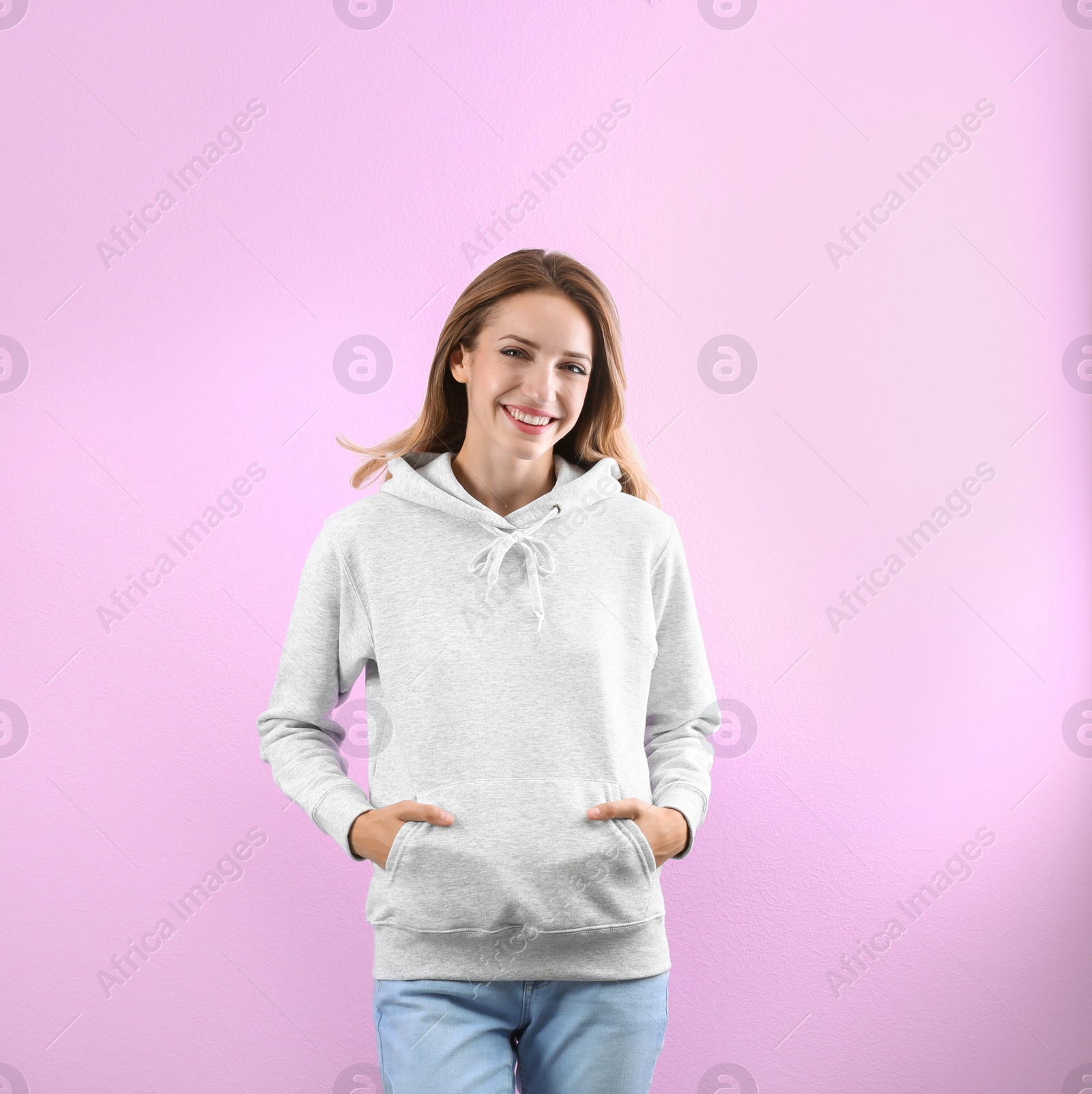 Photo of Portrait of woman in hoodie sweater on color background. Space for design