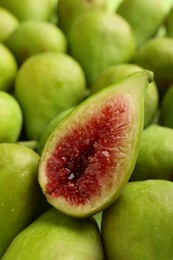 Photo of Half of green fig on fresh fruits, closeup