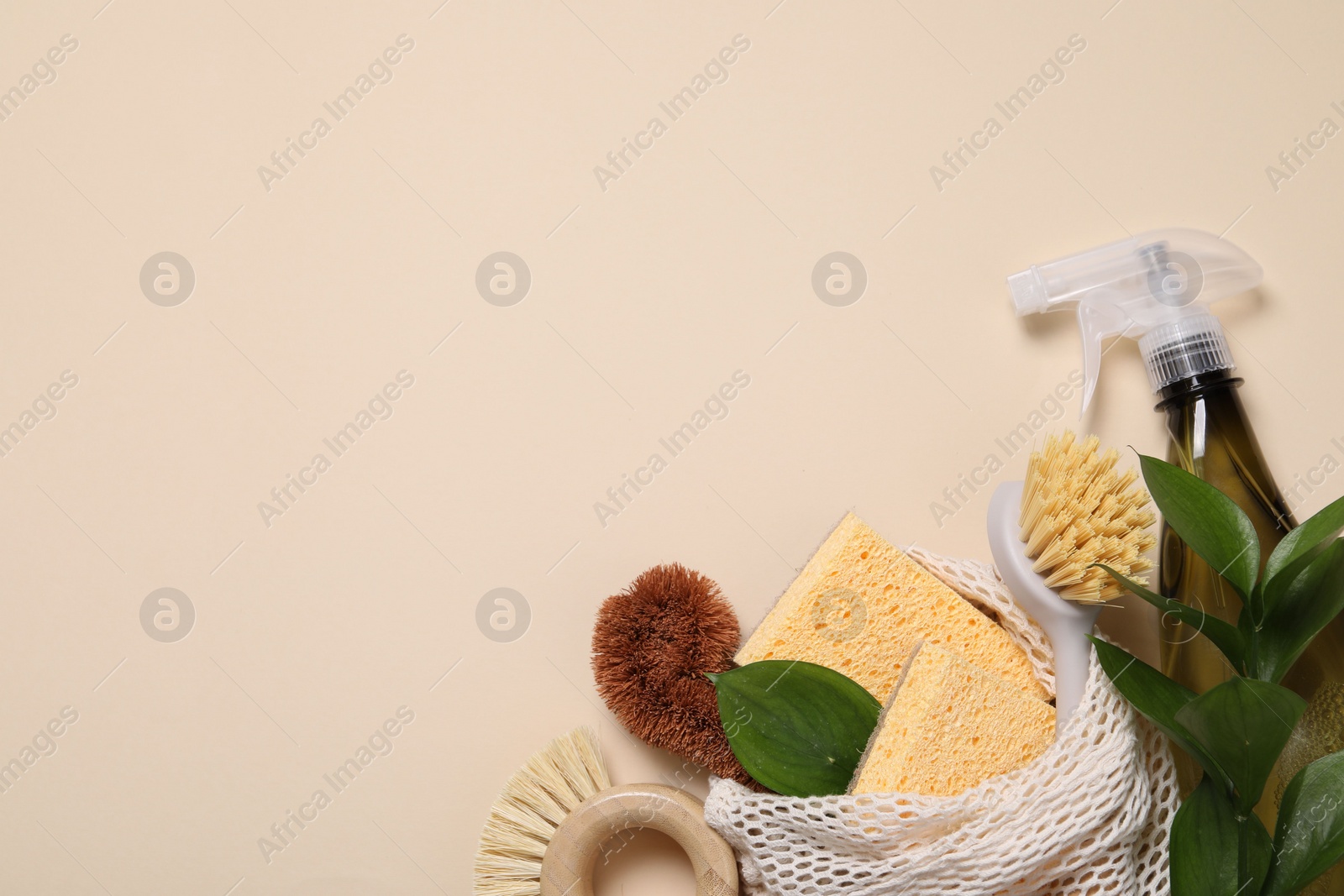 Photo of Flat lay composition with different cleaning supplies on beige background. Space for text