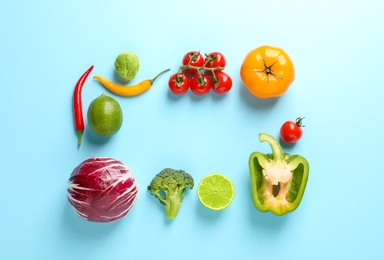 Flat lay composition with fresh vegetables and fruit on color background