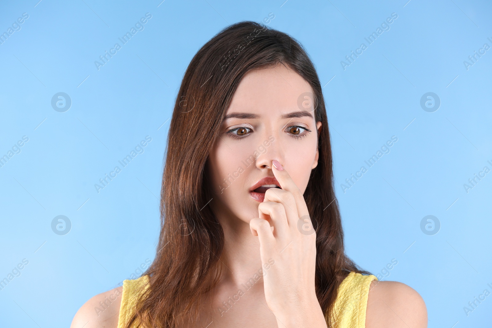 Photo of Teenage girl with acne problem against color background