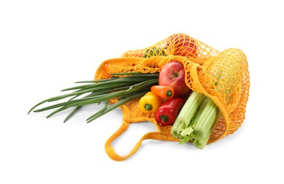 Photo of String bag with vegetables and fruits isolated on white
