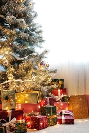 Many different gifts under Christmas tree indoors