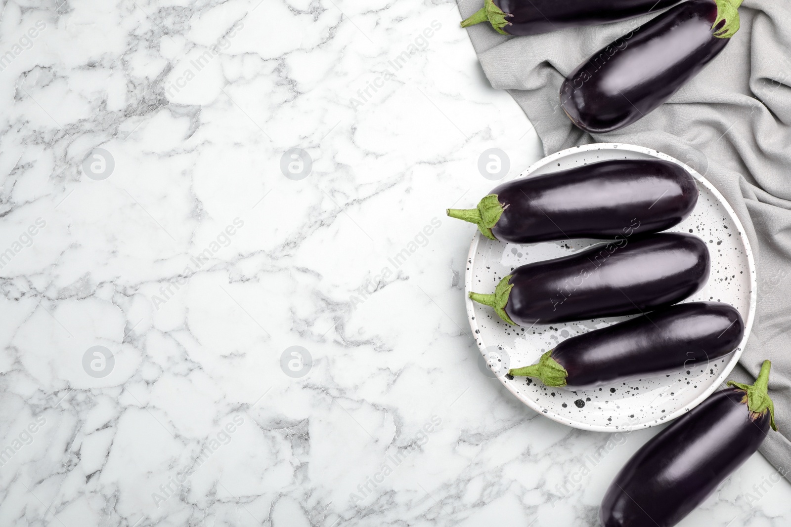 Raw ripe eggplants on marble background, top view Photo of Raw ripe eggplants on marble background, top view