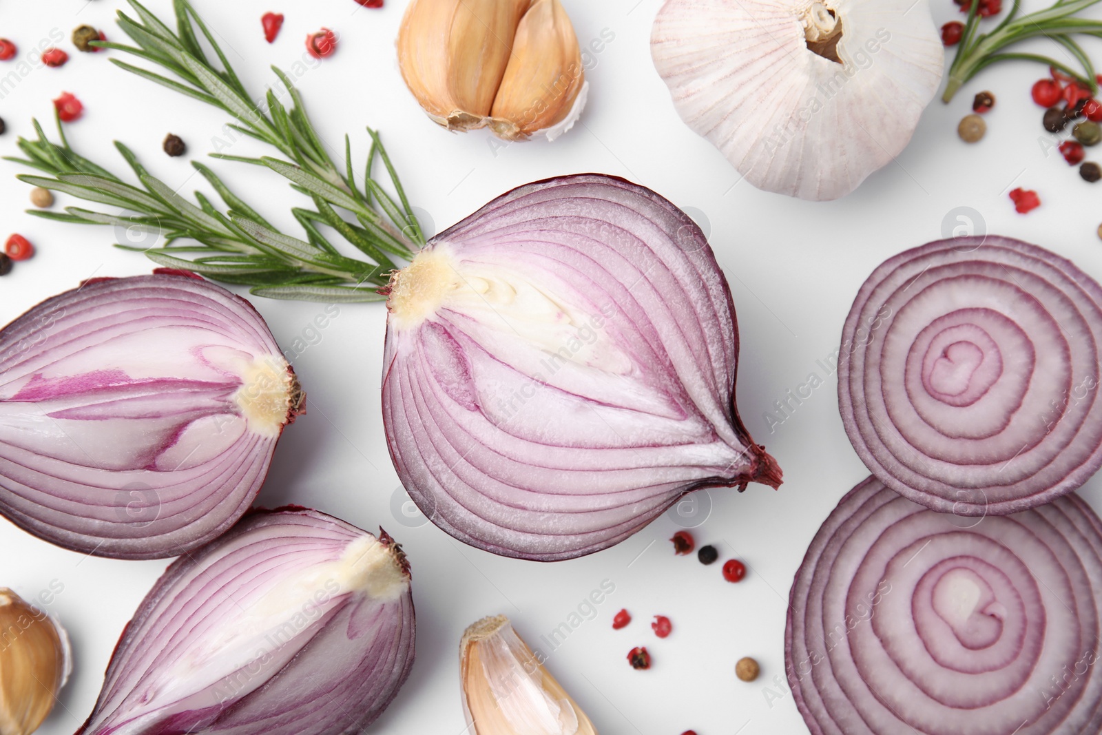 Photo of Fresh red onions, garlic, rosemary and spices on white background, flat lay