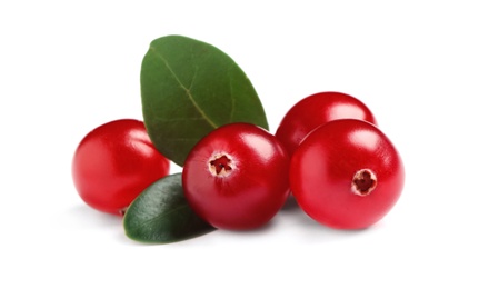 Pile of fresh cranberries with green leaves on white background