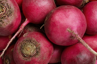 Photo of Pile of red turnips as background, closeup