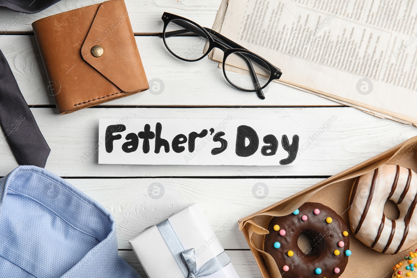 Photo of Flat lay composition with FATHER'S DAY note on white wooden background