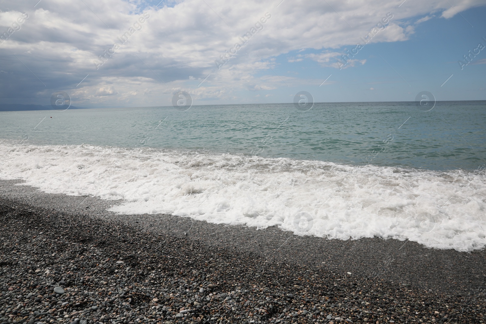 Photo of Picturesque view of beautiful sea shore under sky with clouds