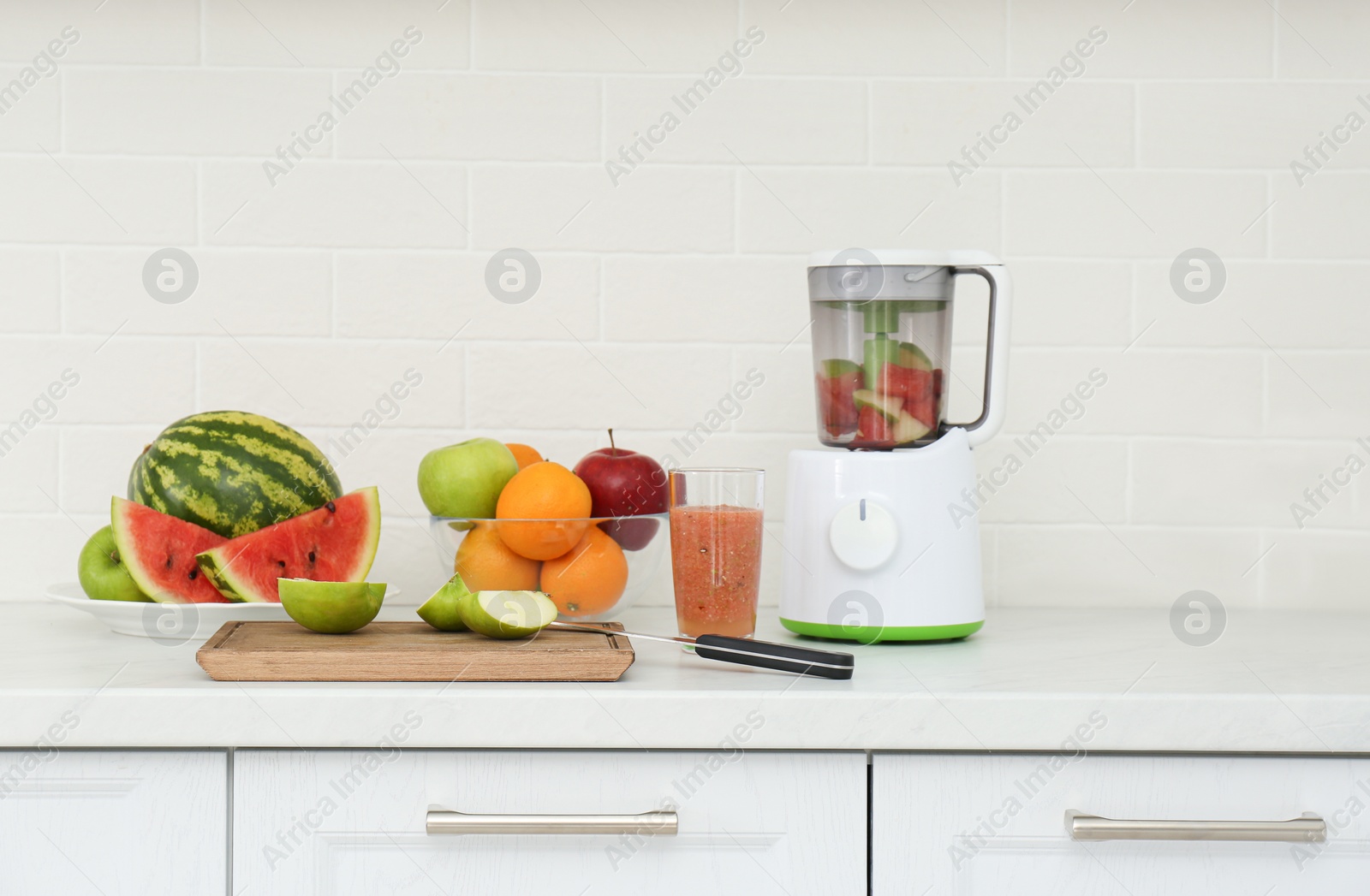 Photo of Blender and smoothie ingredients on counter in kitchen