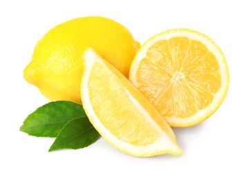 Photo of Cut and whole ripe lemons with green leaves isolated on white