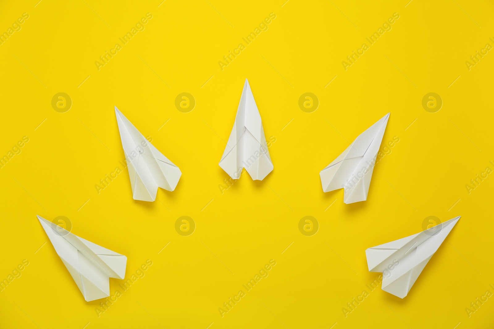 Photo of Flat lay composition with paper planes on yellow background