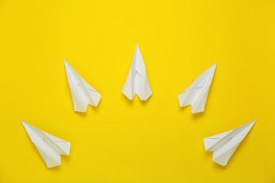 Flat lay composition with paper planes on yellow background