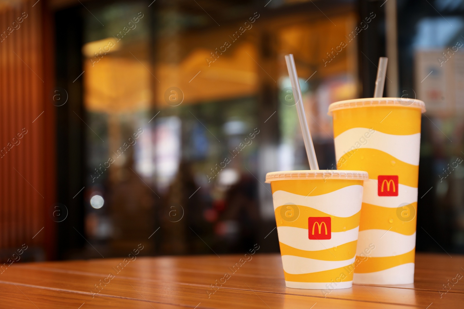 Photo of MYKOLAIV, UKRAINE - AUGUST 11, 2021: Cold McDonald's drinks on table in cafe. Space for text