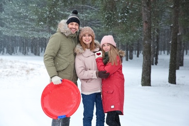 Happy family in forest on snow day