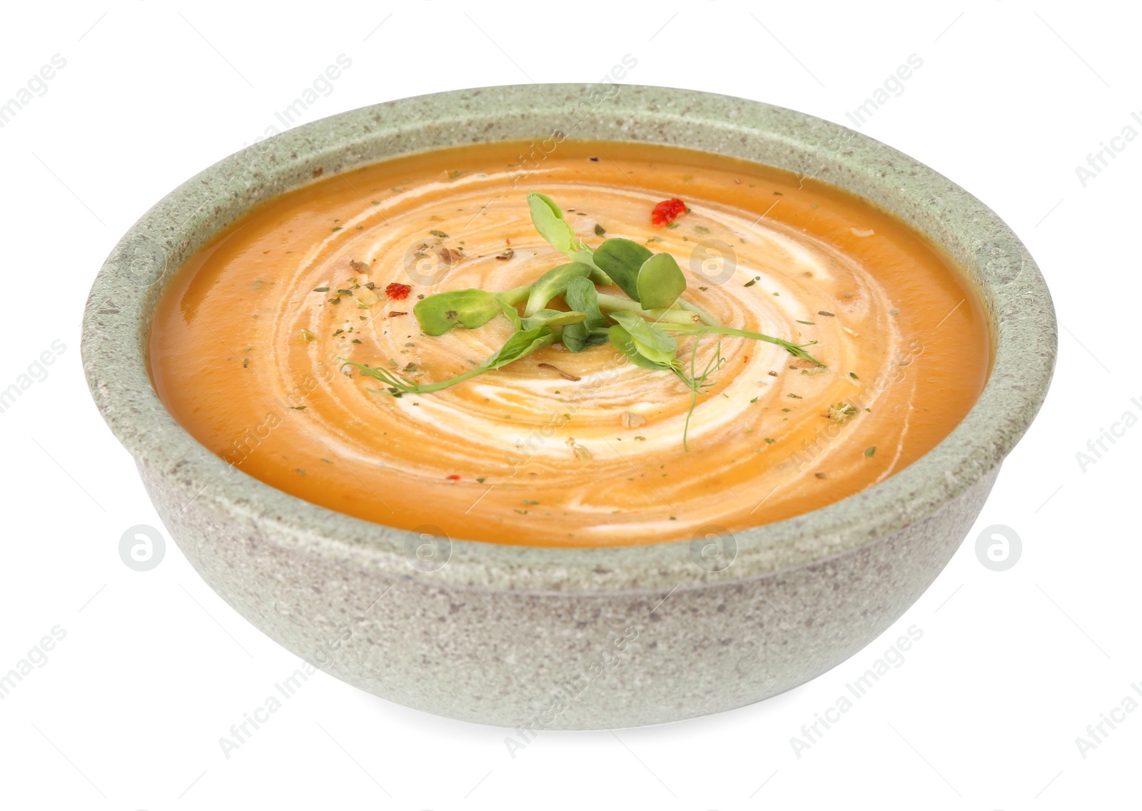 Photo of Delicious pumpkin soup with microgreens in bowl isolated on white
