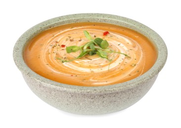 Delicious pumpkin soup with microgreens in bowl isolated on white