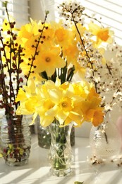 Photo of Yellow daffodils and beautiful branches on windowsill