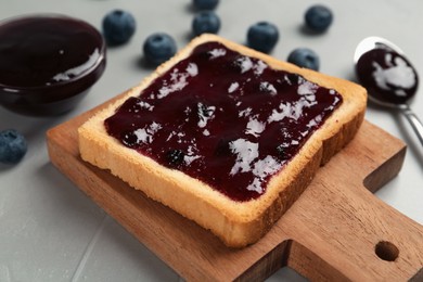 Photo of Toast with blueberry jam served on grey table